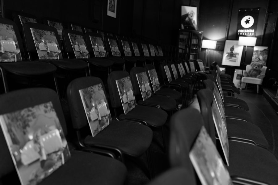 Rows of seats in the auditorium, each carrying a printed record sleeve